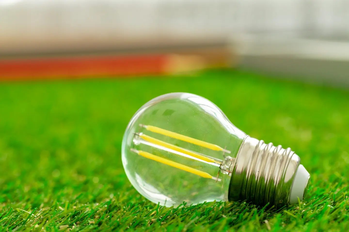 Ampoule LED à filament posée sur l'herbe