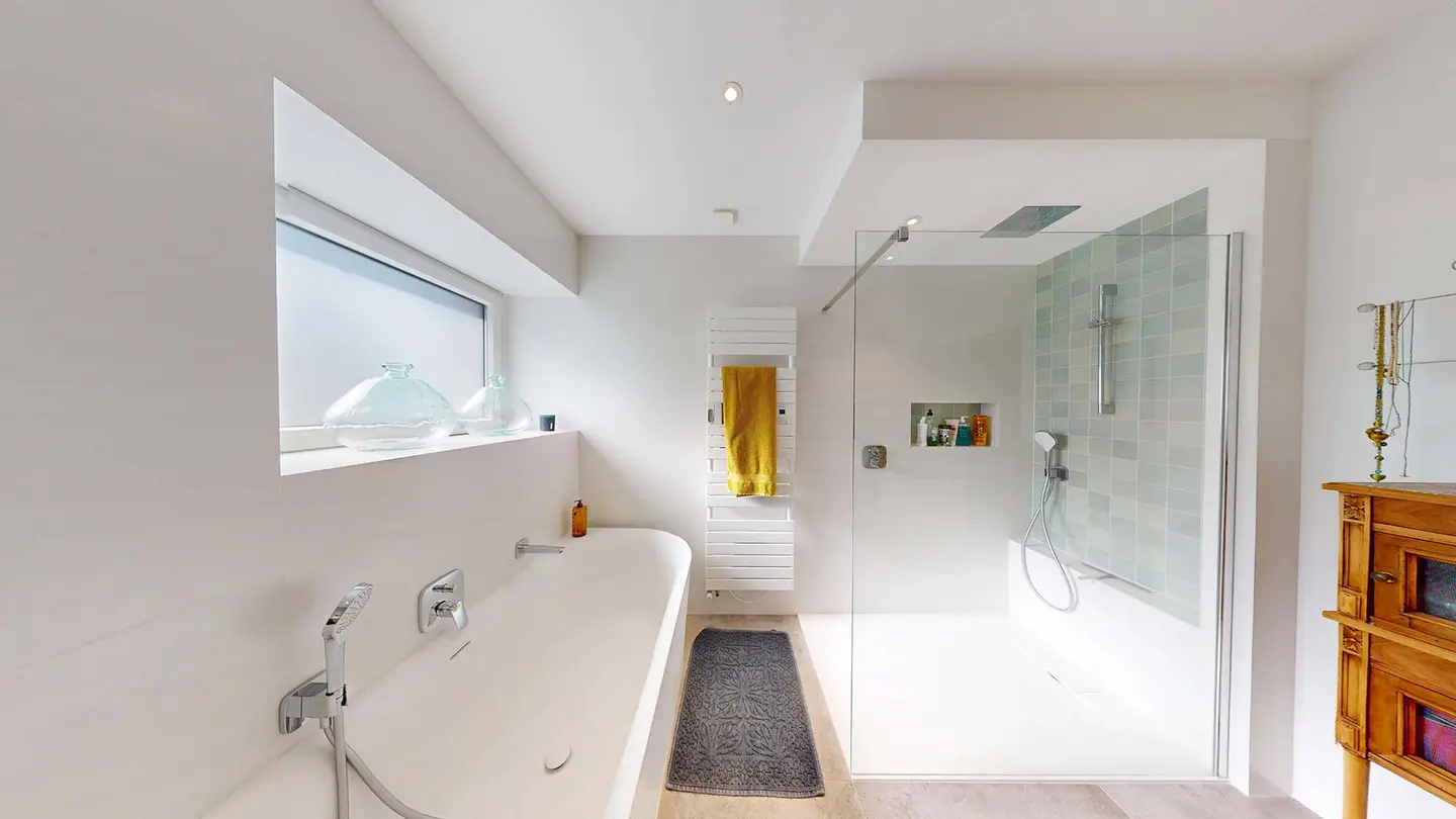 La salle de bain de Plappeville après travaux : baignoire, douche à l'italienne vitrée et niche murale